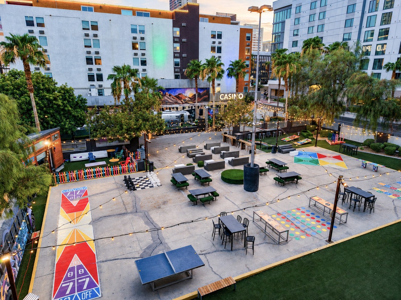 An outdoor courtyard with seating, games, and amenities.