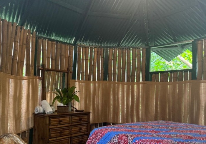 Spacious hut suite at Great Huts eco resort in Portland Jamaica with sitting area and art pieces
